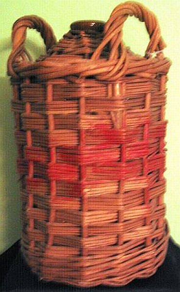 1940s brnir demijon jar encased in weaved cane which held pure british royal navy rum prior to mixing it into grog