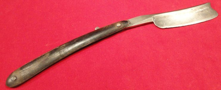 photo showing 19th century us navy straight razor stamped USN on the blade