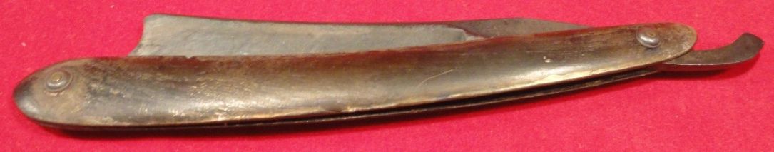 photo showing 19th century us navy straight razor stamped USN on the blade