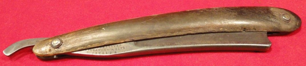 photo showing 19th century us navy straight razor stamped USN on the blade