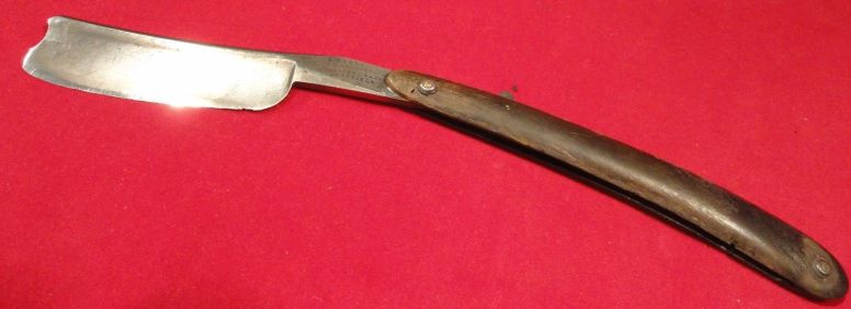 photo showing 19th century us navy straight razor stamped USN on the blade