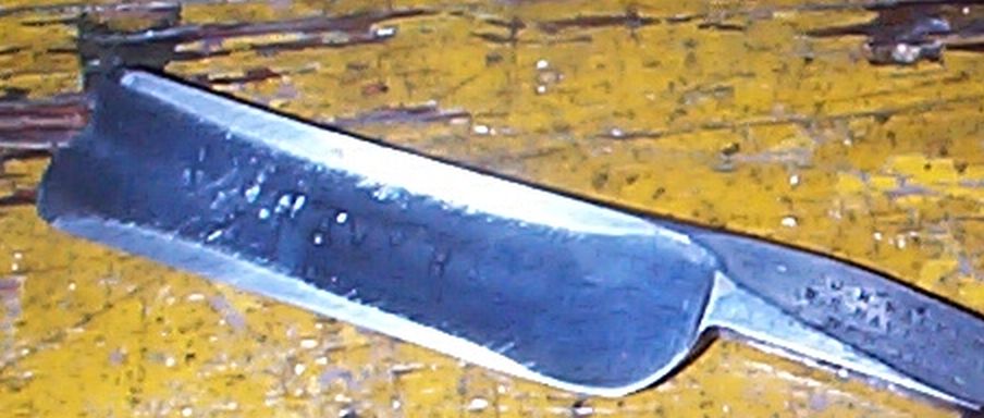 photo showing 19th century us navy straight razor stamped USN on the blade