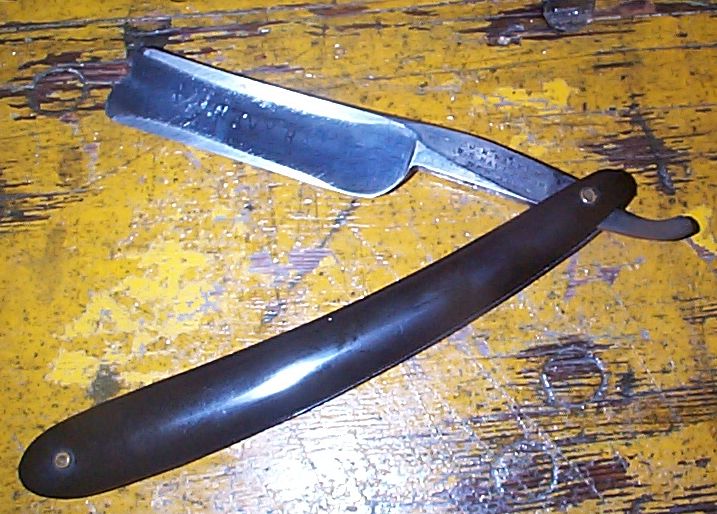 photo showing 19th century us navy straight razor stamped USN on the blade