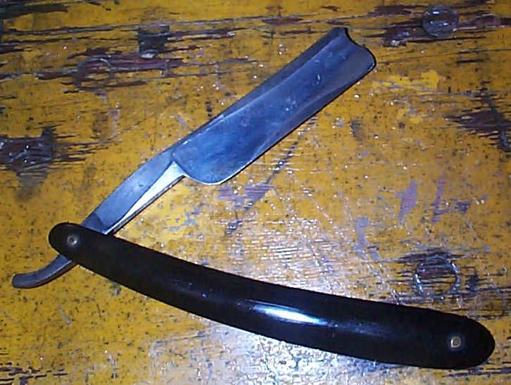 photo showing 19th century us navy straight razor stamped USN on the blade