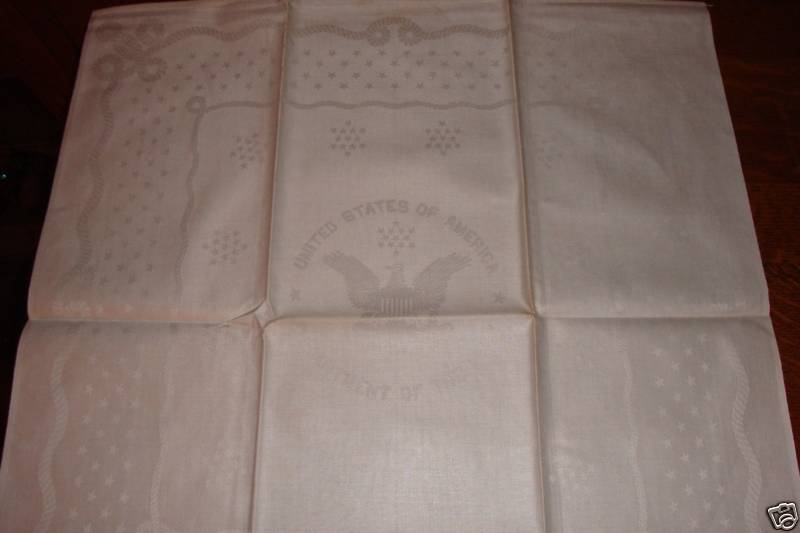 navy napkin with weaved twisted rope and department of navy seal design
